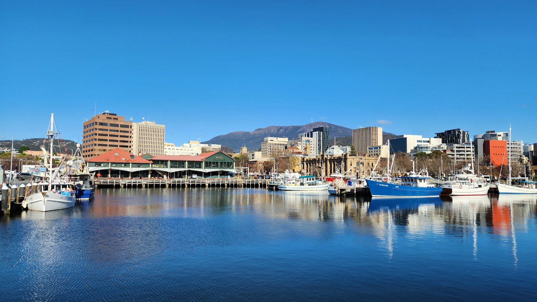Boats on Hobart’s waterfront beneath kunanyi / Mount Wellington